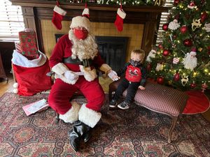 Ryan holding hands with Santa