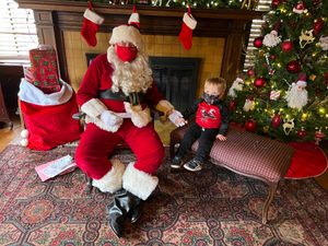 Ryan holding hands with Santa