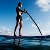 A woman paddling a kayak.